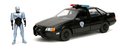 Autíčko RoboCop Ford Taurus 1986 Jada kovové s otvárateľnými časťami a figúrkou Robocop dĺžka 20 cm 1:24
