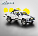 Autíčko Collection 1985 Toyota Hilux SR5 Pick Up Majorette mașinuță metalică în cutie de expunere, cu roți din cauciuc, lungime 7,5 cm, 1:64