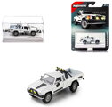 Autíčko Collection 1985 Toyota Hilux SR5 Pick Up Majorette mașinuță metalică în cutie de expunere, cu roți din cauciuc, lungime 7,5 cm, 1:64